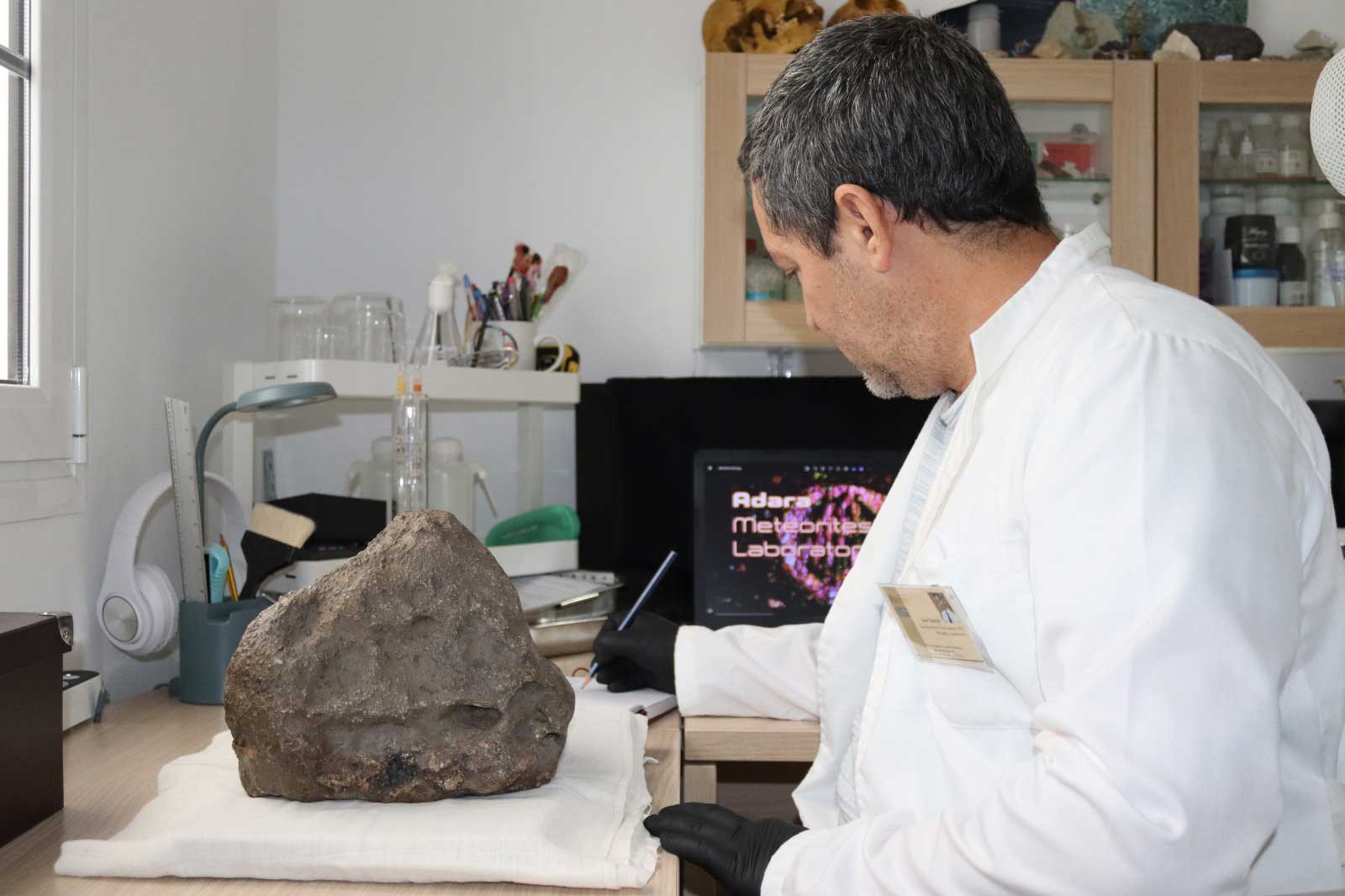 Hands preparing specimens and documentation in the lab